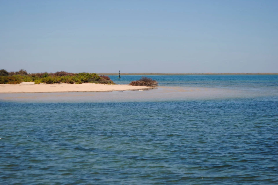 A tiny islet surrounded by crystal blue water