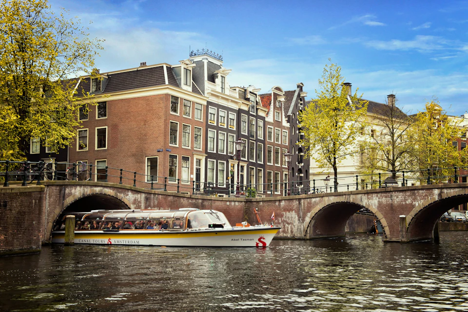 Cruise in the Amsterdam canals going under a bridge