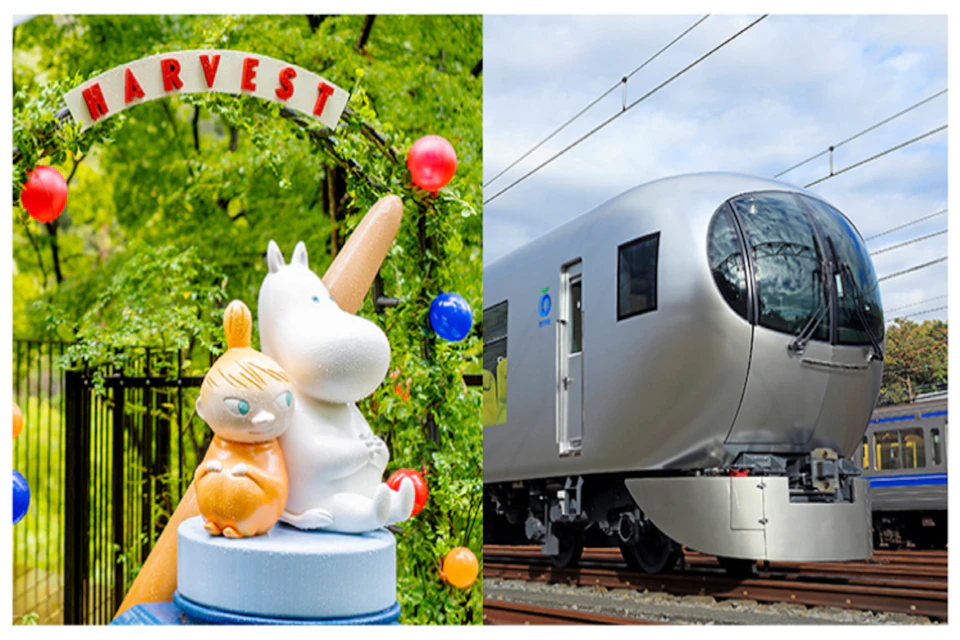A white and orange character cake topper in a garden next to a sleek, silver train on tracks.