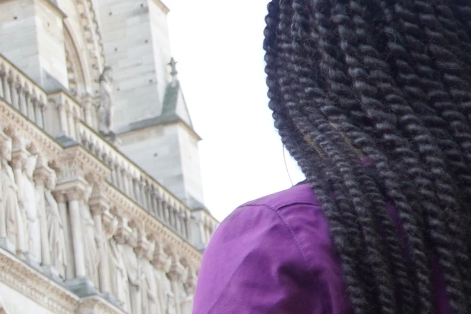 A guide in front of Notre Dame Cathedral talking to a small group of guests