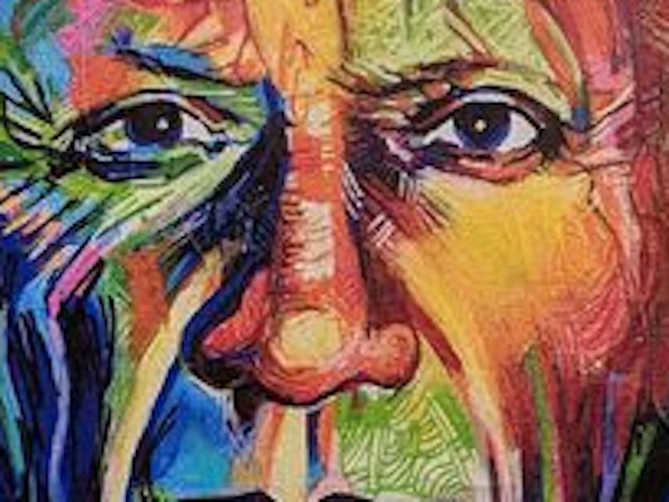 Colorful mural of an older man's face on a yellow wall, with vibrant, abstract background elements and a small window to the right.