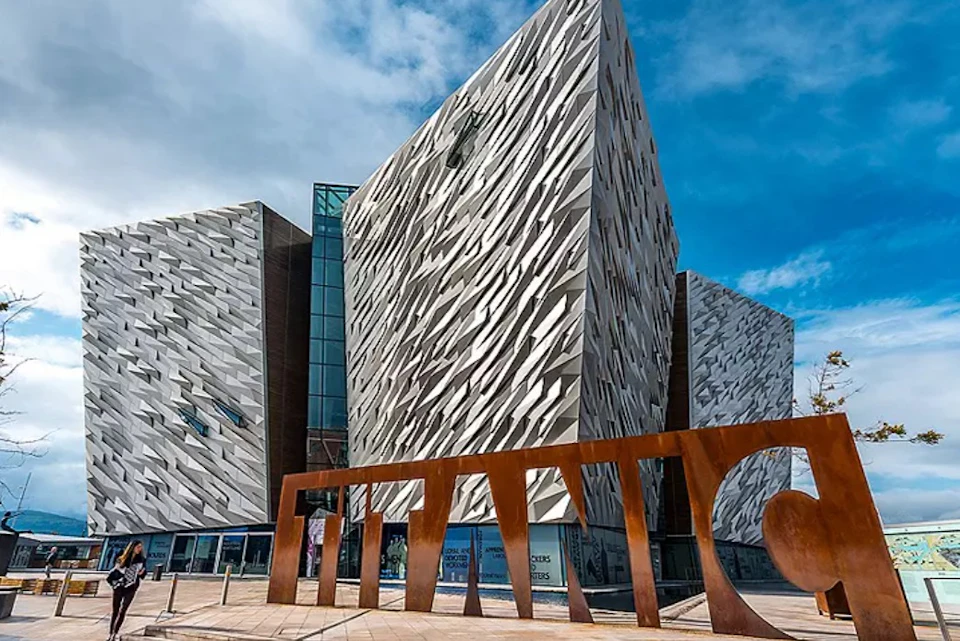 Modern building with angular, textured metal facade, labeled "TITANIC" in large letters in the foreground.