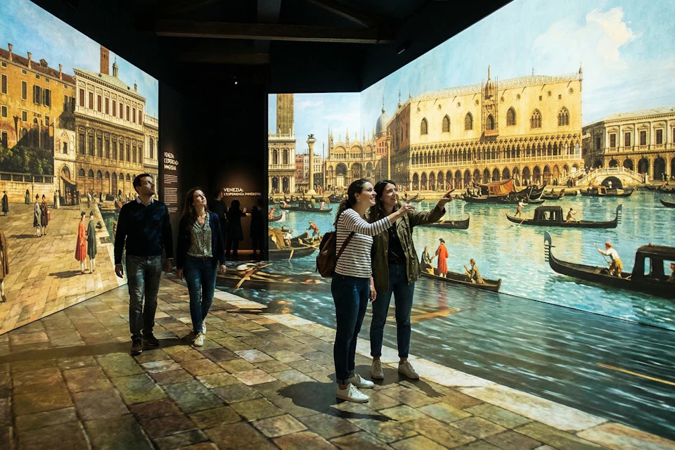People observing a digital exhibition of Venetian landmarks projected onto walls, featuring canals and architecture.