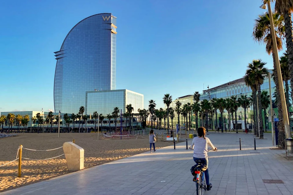 La Barceloneta with its beach, palm trees and the prestigious W Barcelona hotel.