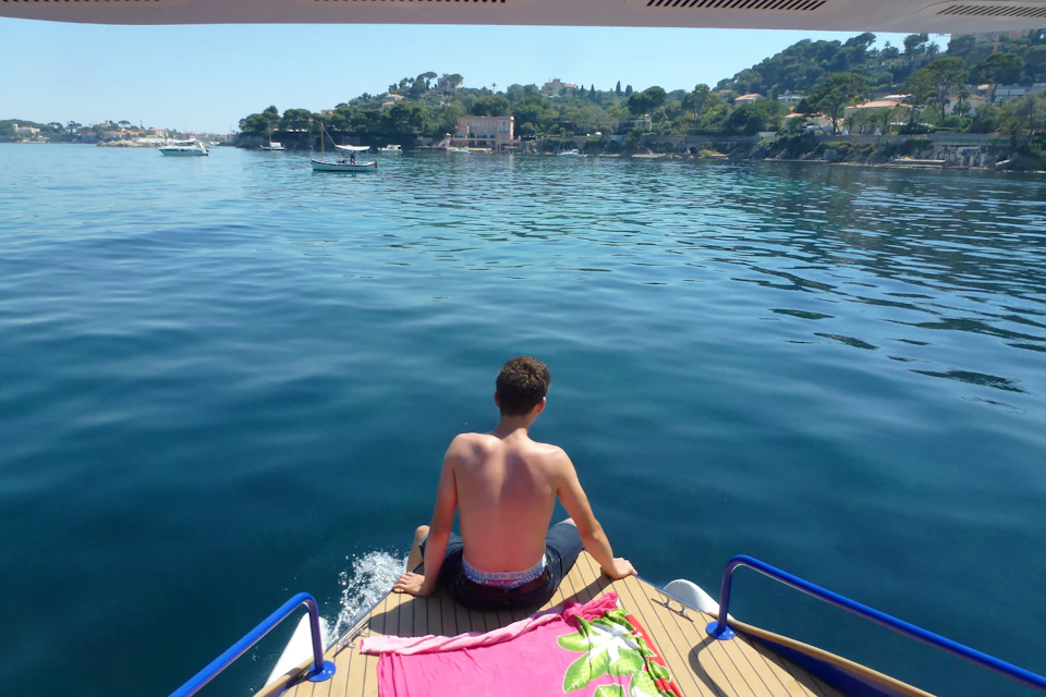 Sitting forward with feet in the water