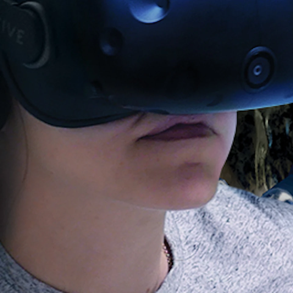 Two people wearing VR headsets, holding controllers, immersed in a space-themed virtual reality environment with stars in the background.