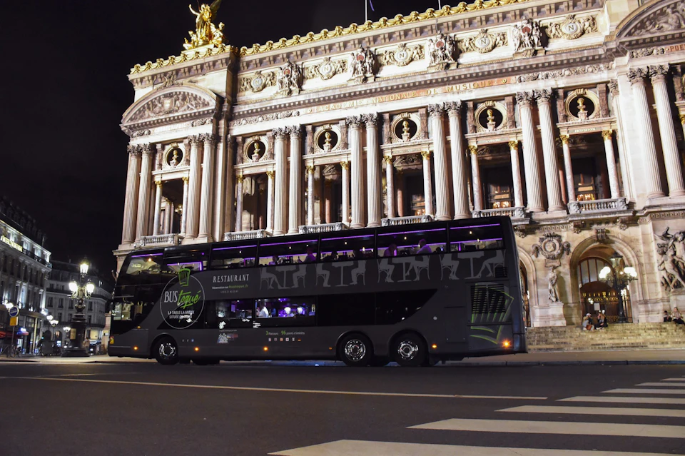 The Bus Toqué Champs-Elysées in front of the Paris Opera by night