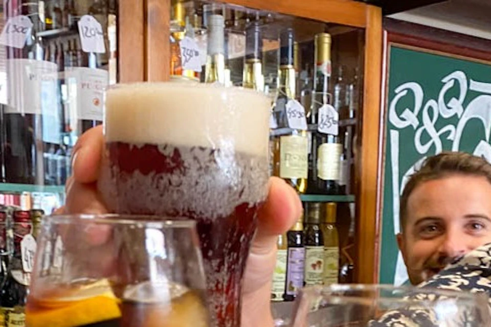 Tasting local drinks such as vermouth or beer.