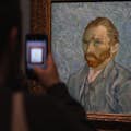 Someone taking a photo of Vincent van Gogh's self-portrait at the Musée d'Orsay