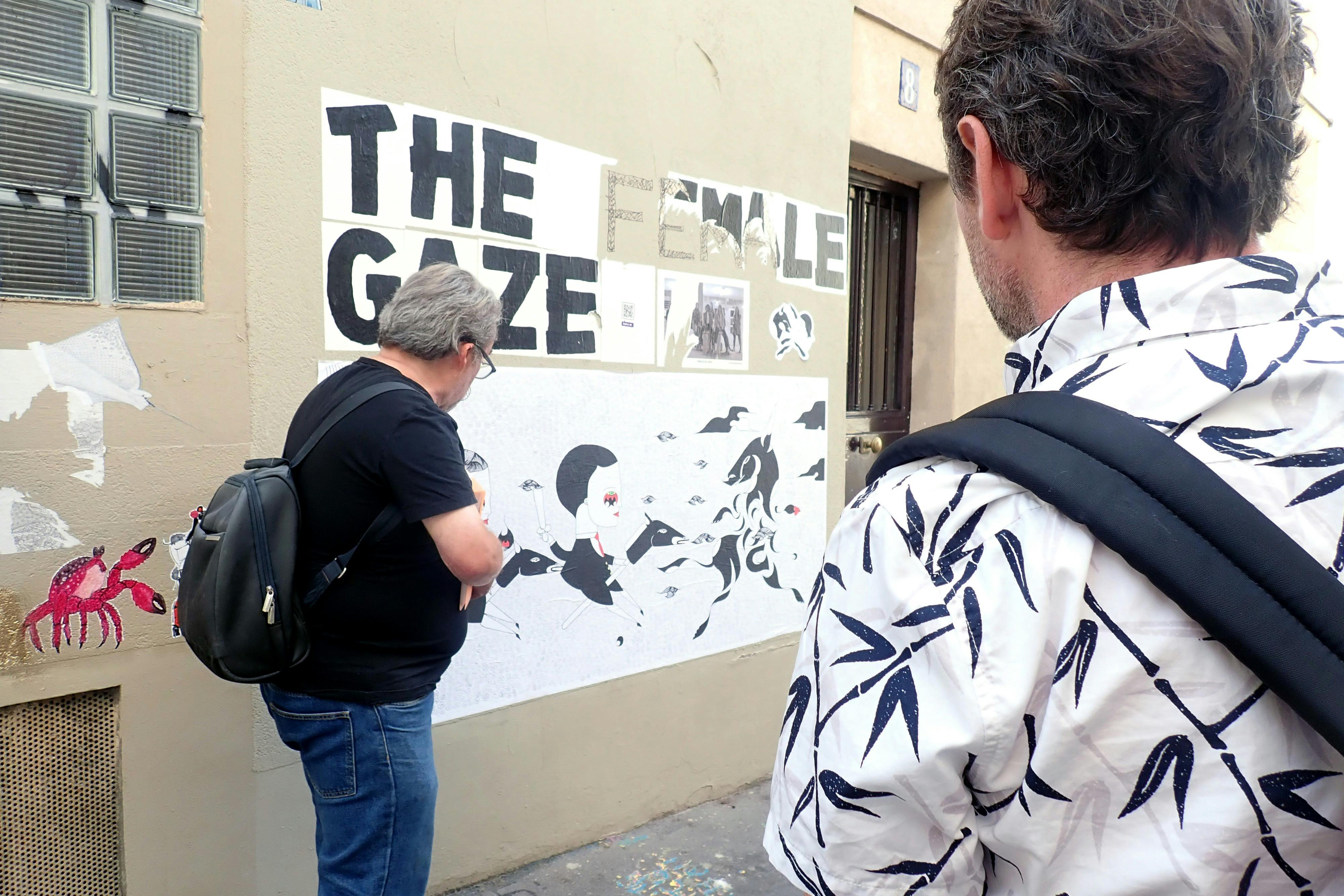 Guide explaing a mural to guests