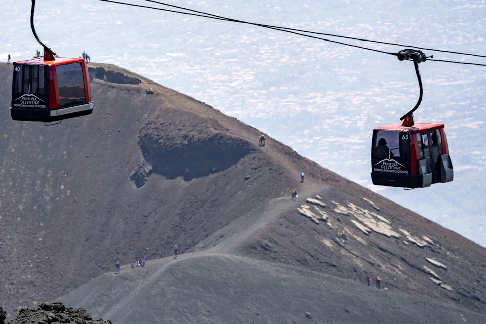 Cabins, crater and people walking
