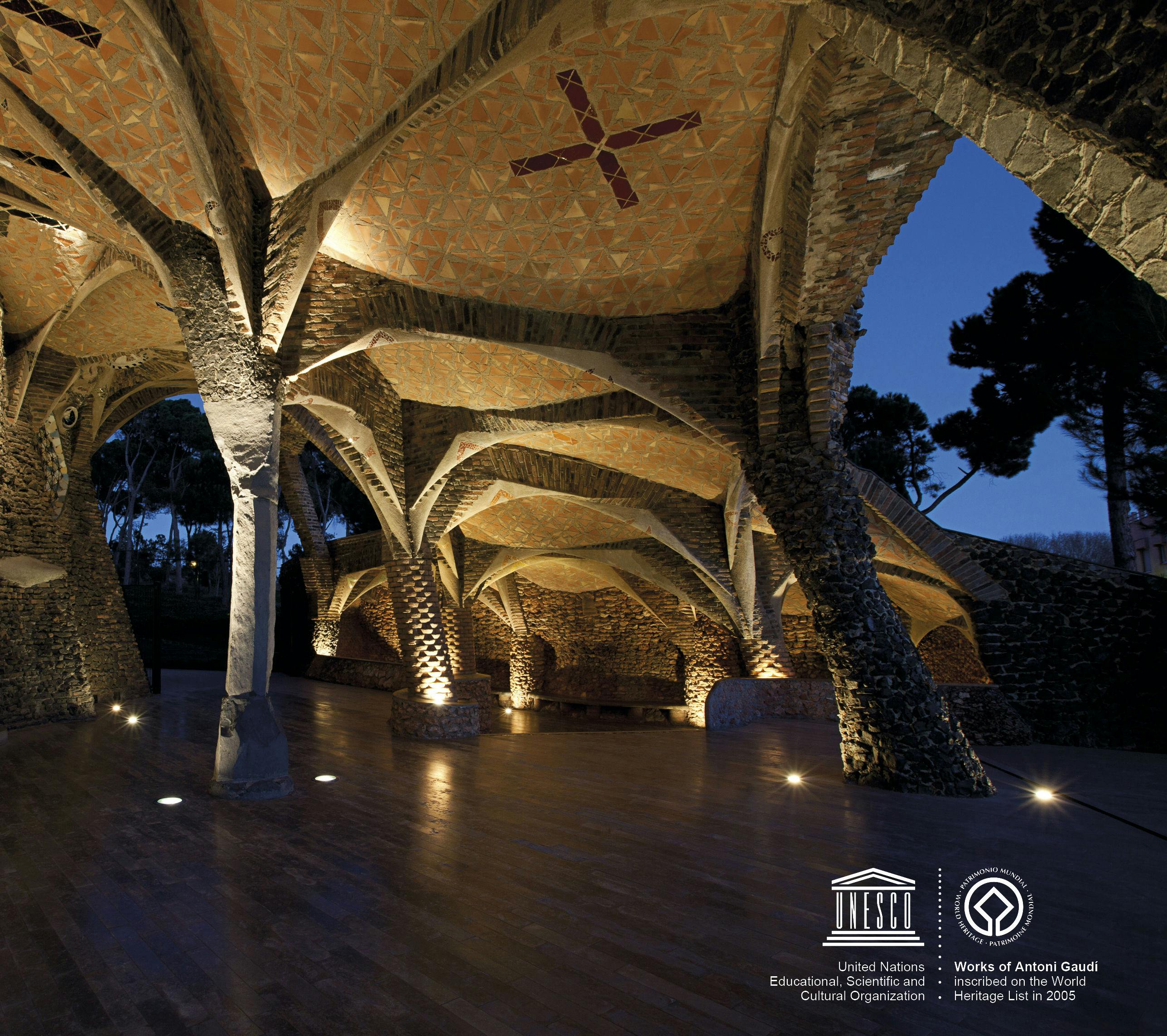 The image shows a vaulted, stone interior with unique columns and lighting. UNESCO and World Heritage logos are present in the bottom right corner.