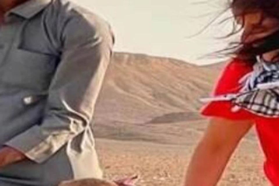 Child plays with camel