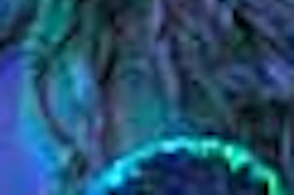 Performers in traditional attire dance energetically on stage with vibrant blue and green lighting in the background.