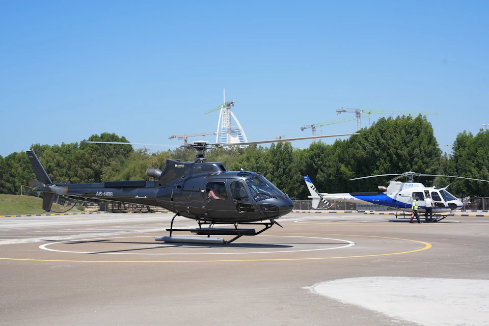 Black and Blue and White HeliDubai helicopters.