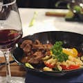 Red wine paired with Beef Stew served with traditional noodles