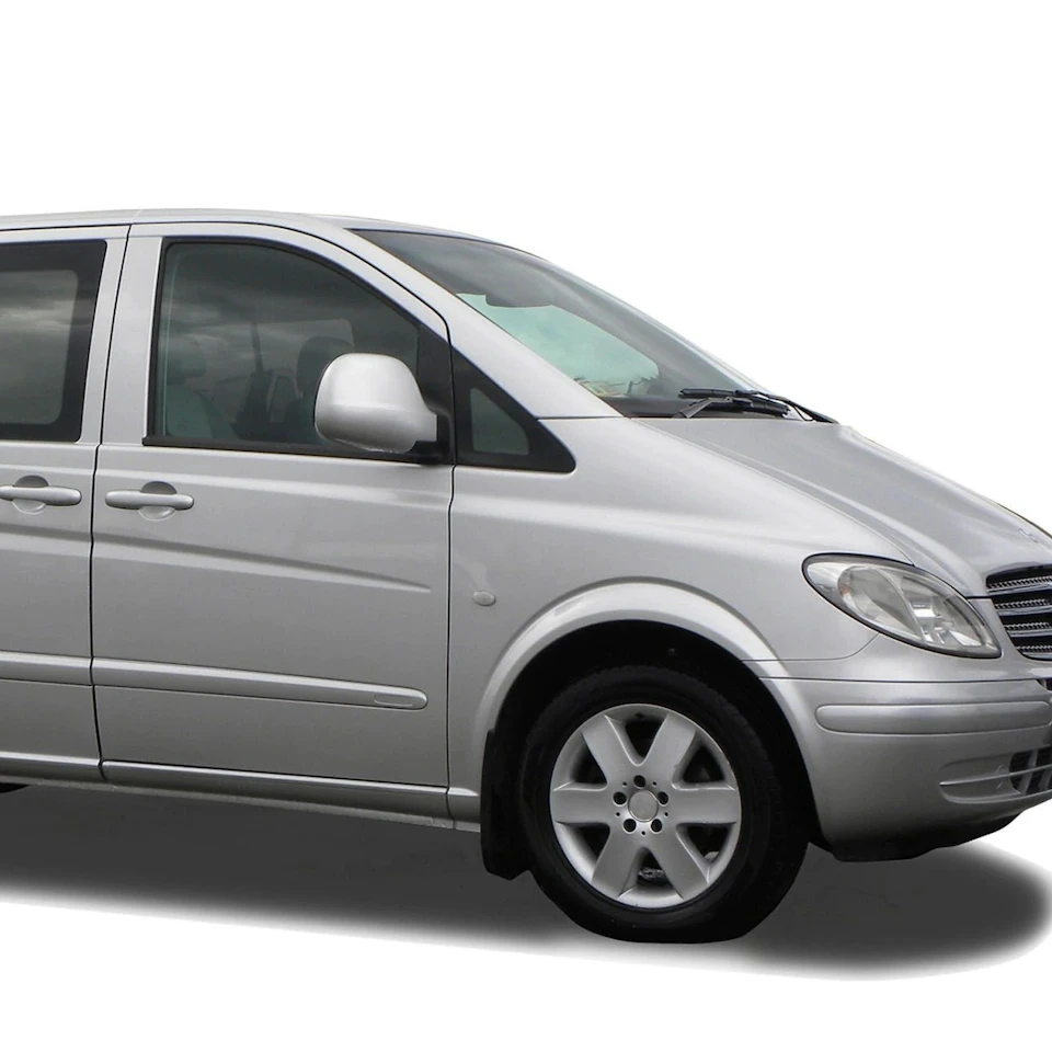 A silver minivan with tinted windows and alloy wheels, viewed from the front and passenger side against a white background.