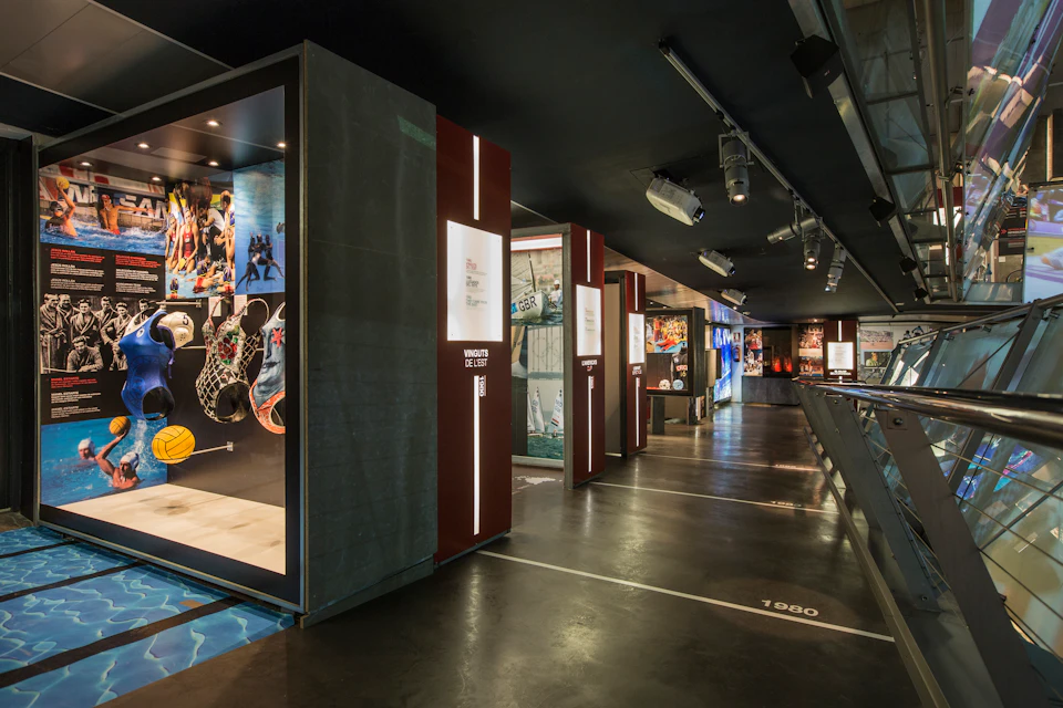 Exhibit hall with timeline markings on the floor, illuminated display cases, and various informational panels.
