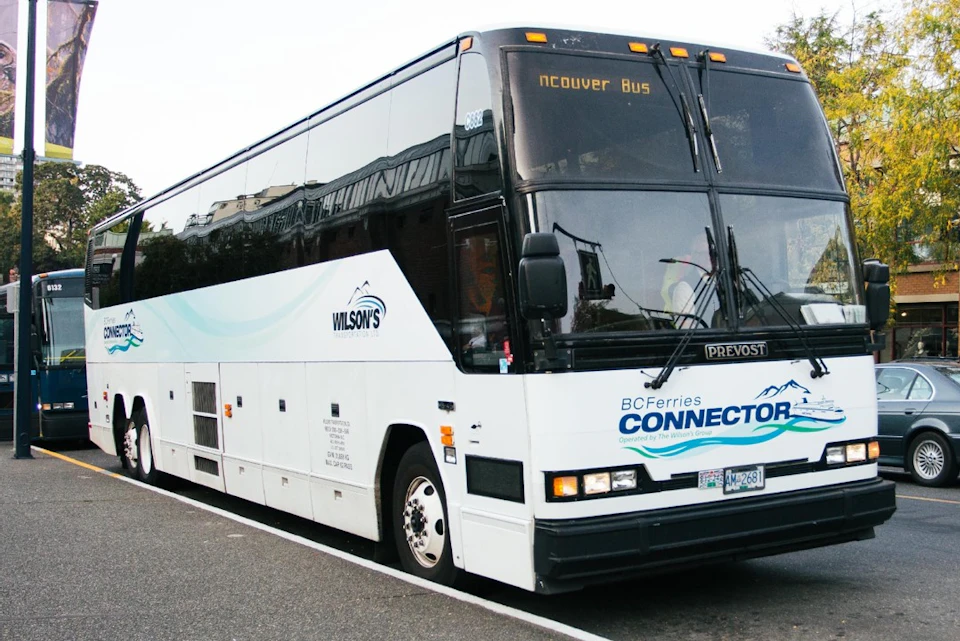 A white Wilson's BC Ferries Connector bus parked on a street, with "Vancouver Bus" displayed on the front sign.