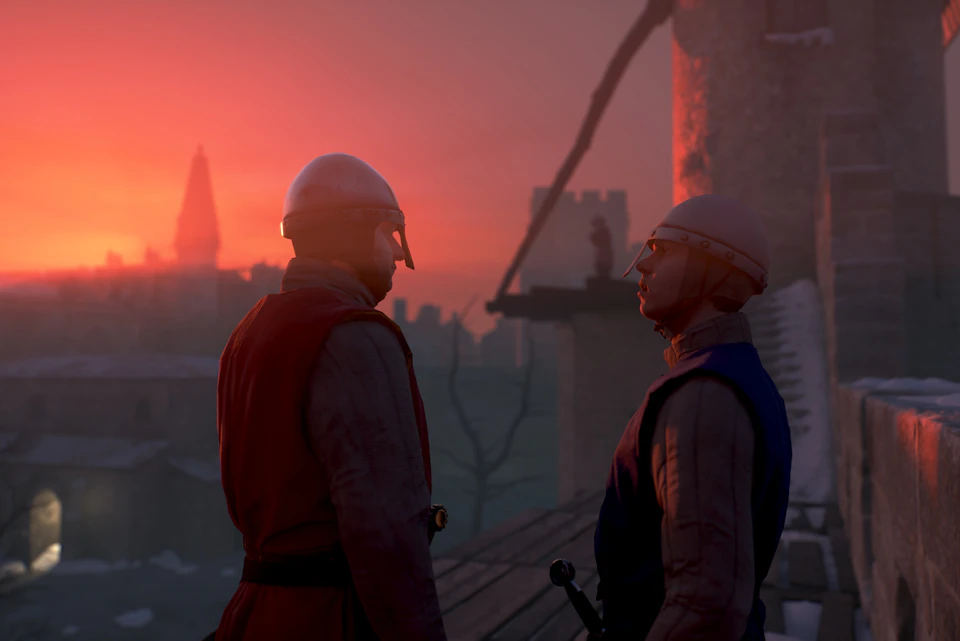 Two armored medieval soldiers stand on a rooftop at sunset, with a distant figure on a tower and a city skyline in the background.