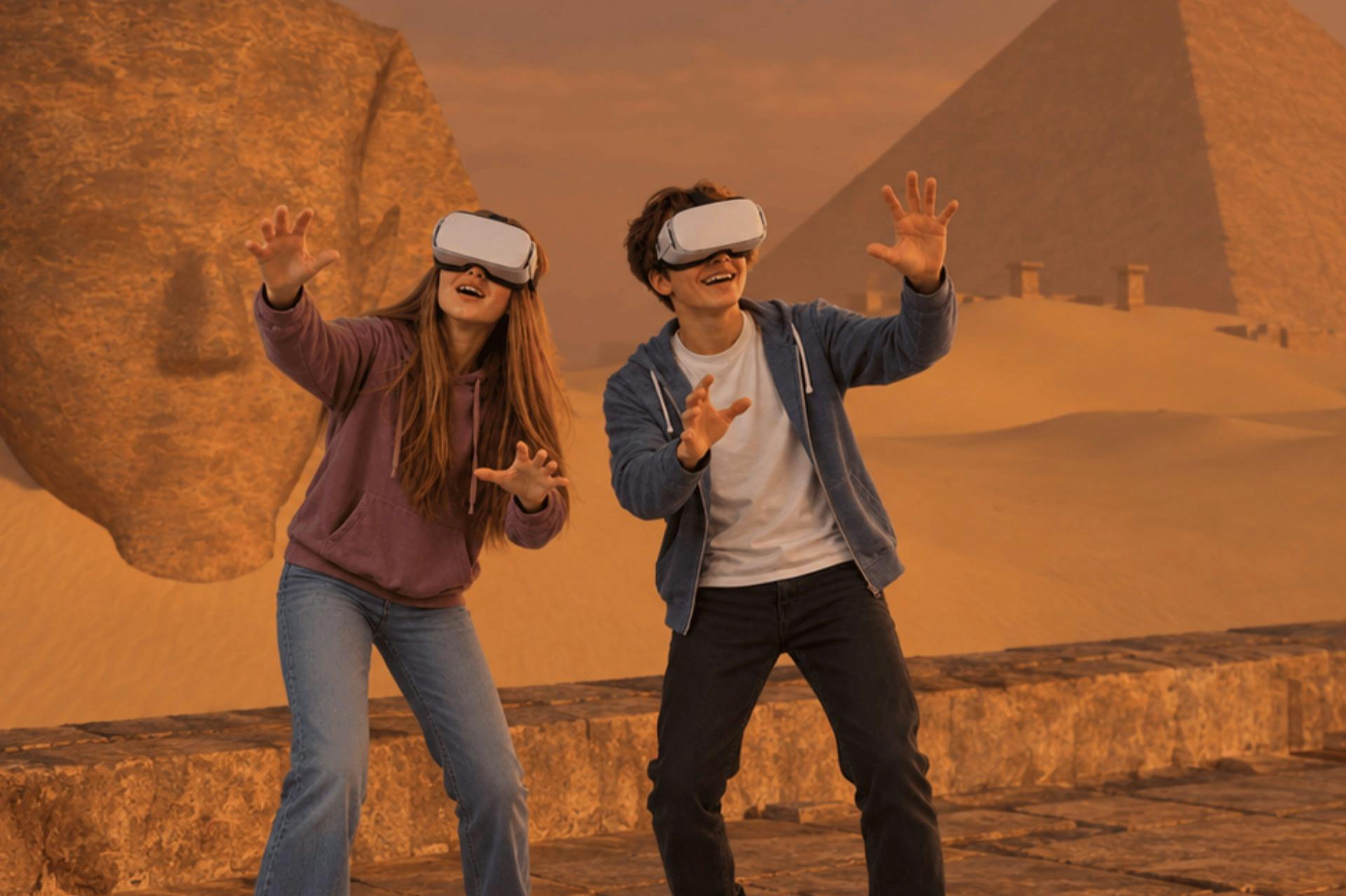 Two people wearing VR headsets interacting in a desert setting with pyramids and a large sculpture in the background.