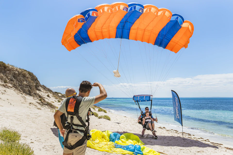 Tandem skydive pair landing on Rottnest Island beach