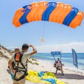 Una pareja de paracaidistas en tándem aterriza en la playa de la isla Rottnest