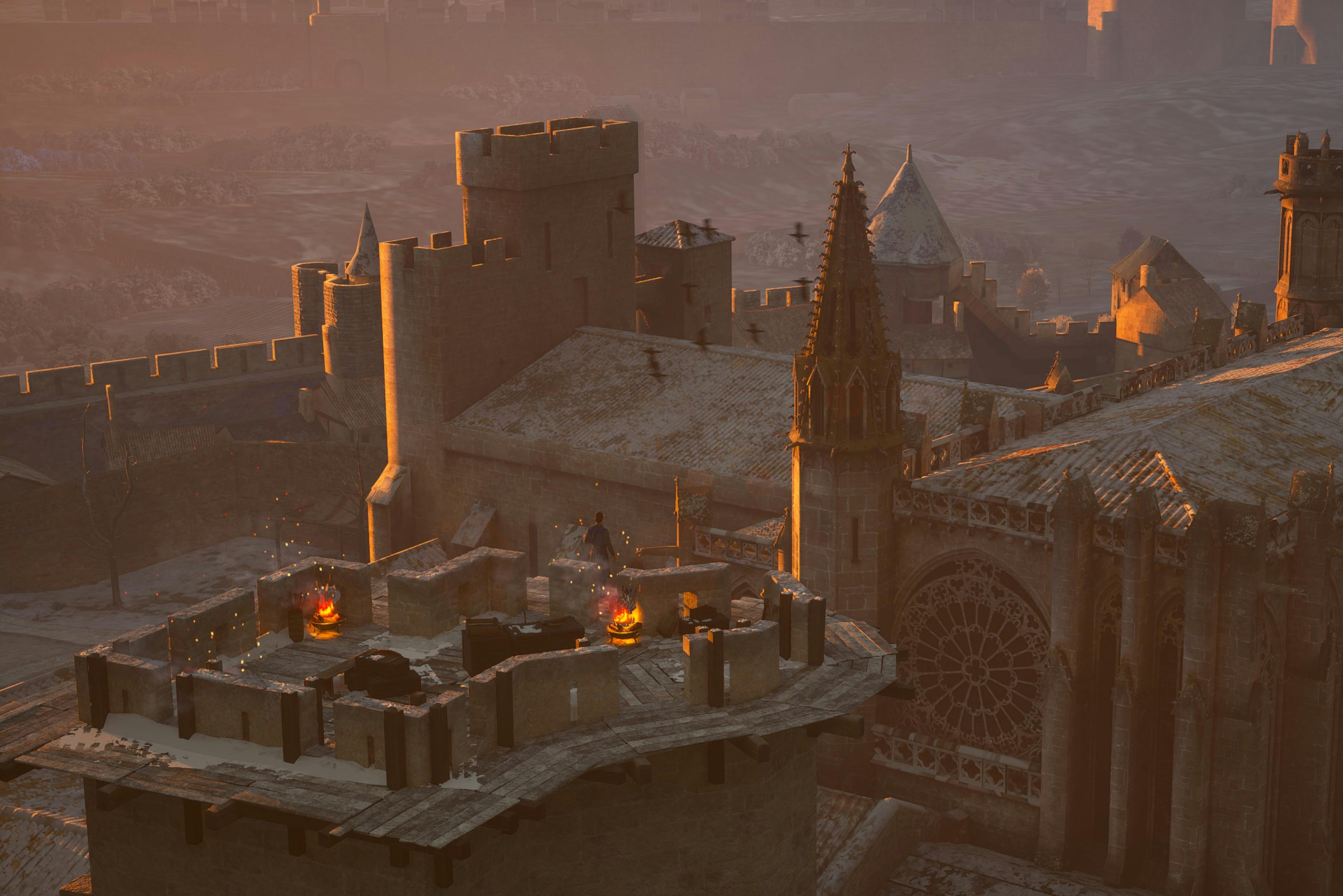 Medieval castle rooftops at sunset, with spires, a circular stained glass window, and figures on a turret amid glowing artifacts.
