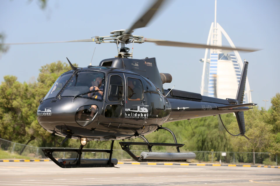 HeliDubai helicopter taking off with Burj Al Arab at the background.