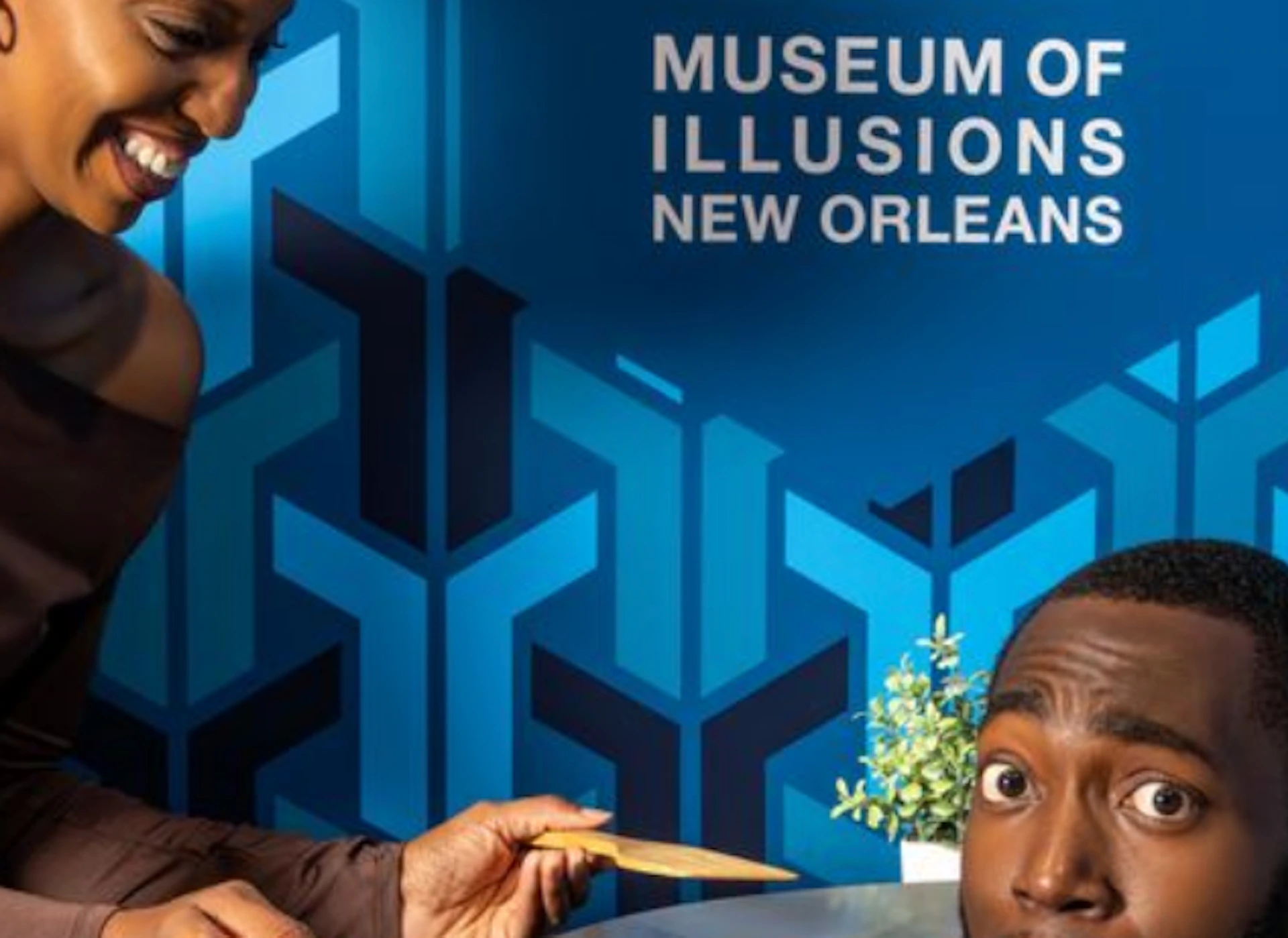 A woman playfully interacts with a man's head appearing on a table at the Museum of Illusions in New Orleans.