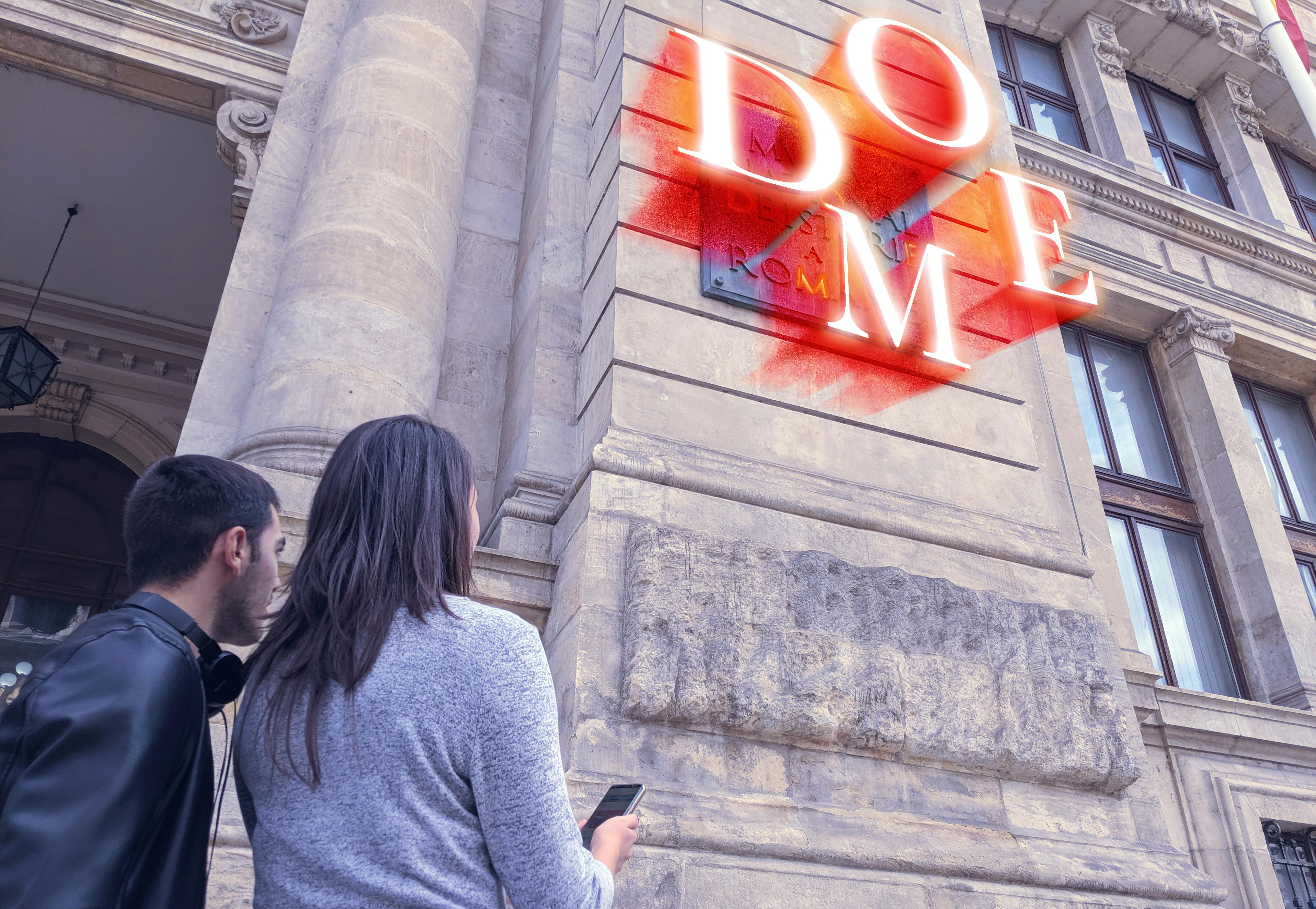 Two people standing near a stone building with columns and a partially visible red neon sign. One holds a smartphone.