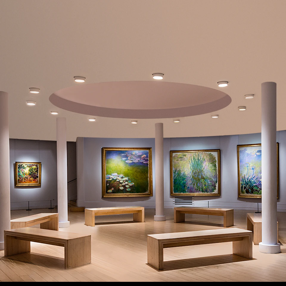 Art gallery interior with wooden benches and several large framed paintings displayed on curved gray walls under ceiling lights.