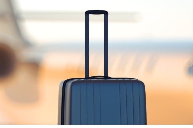 Someone carrying their luggage