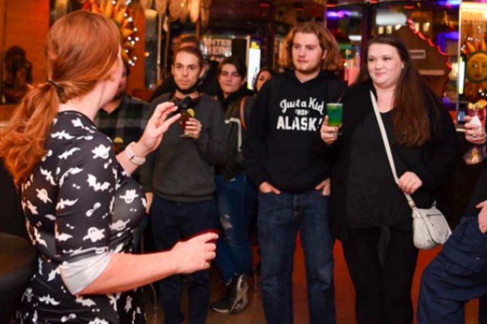 Tour guide sharing spooky tales to guests