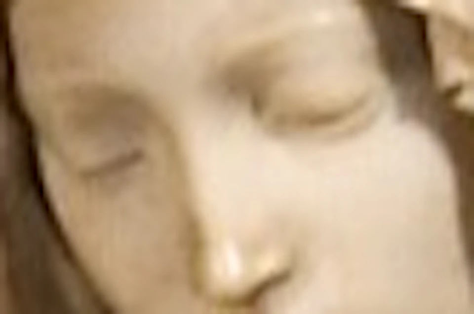 A marble sculpture of a seated woman holding a lifeless man, placed against a marble patterned background.
