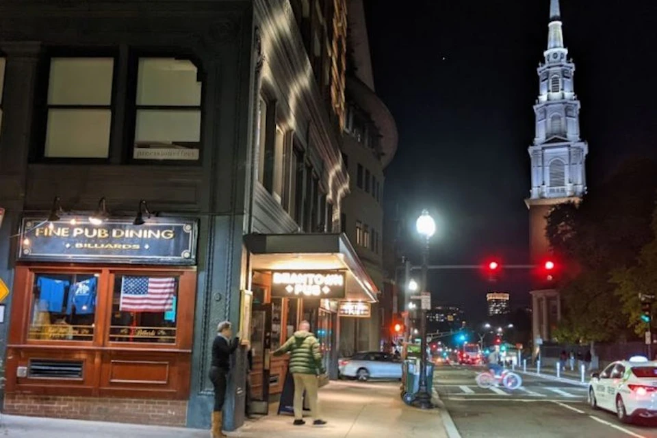 Nighttime photo from afar of the Beantown Pub