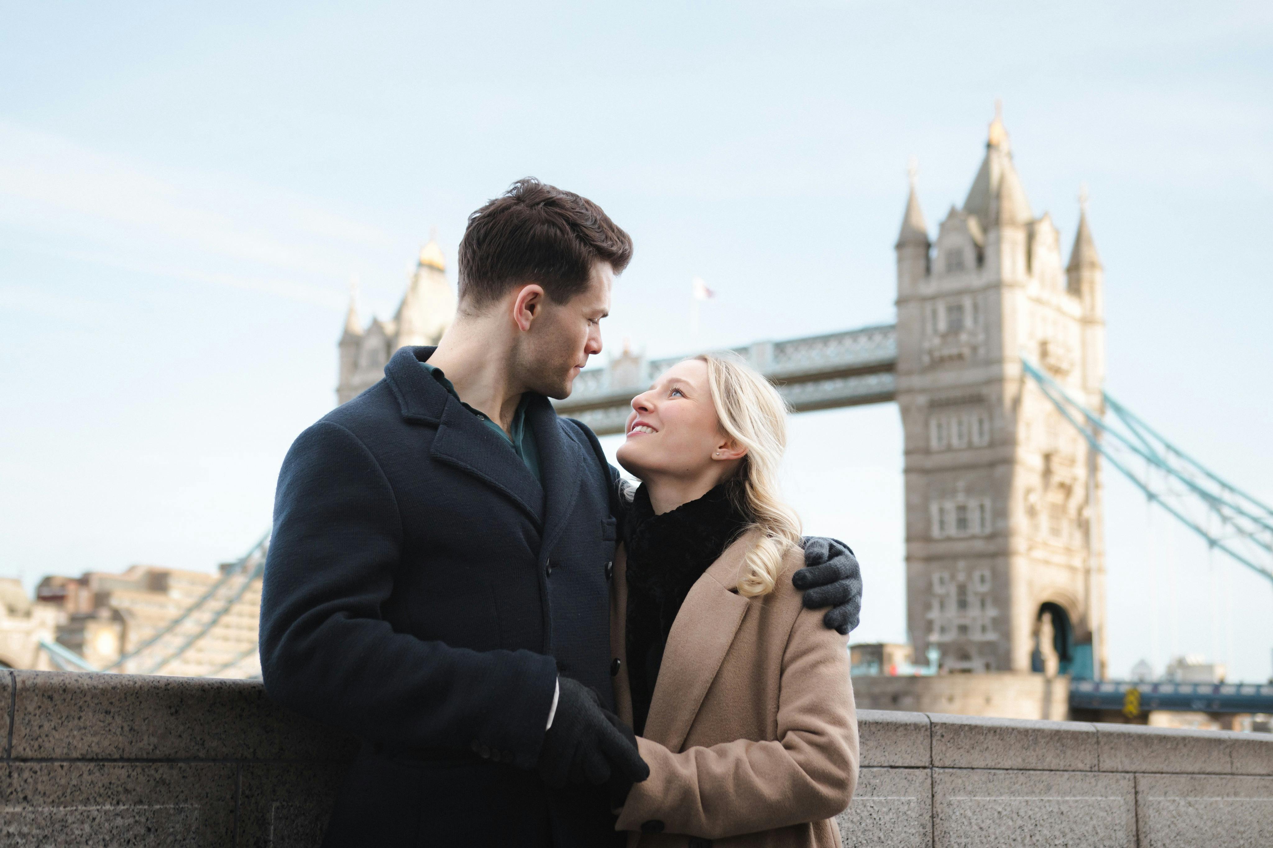 A couple enjoying their photoshoot in front of the iconic Tower Bridge