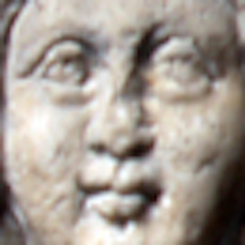 Stone relief of a figure with outstretched hands, wearing draped robes, flanked by ornate, arched patterns on both sides.