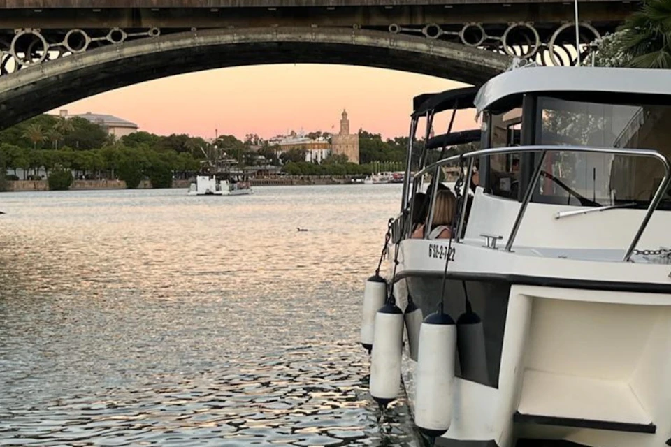The company's boat with the Torre del Oro and the Isabel II bridge in the background
