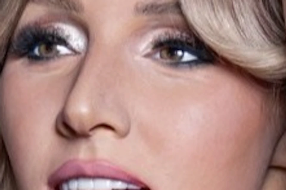 A wax figure of a woman holding a microphone, dressed in pink sequined clothing, displayed at Madame Tussauds Wien.