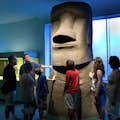A group admiring an Easter Island moai inside the American Museum of Natural History in New York.