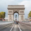 Long exposure shot of the Arc de Triomphe in daylight.