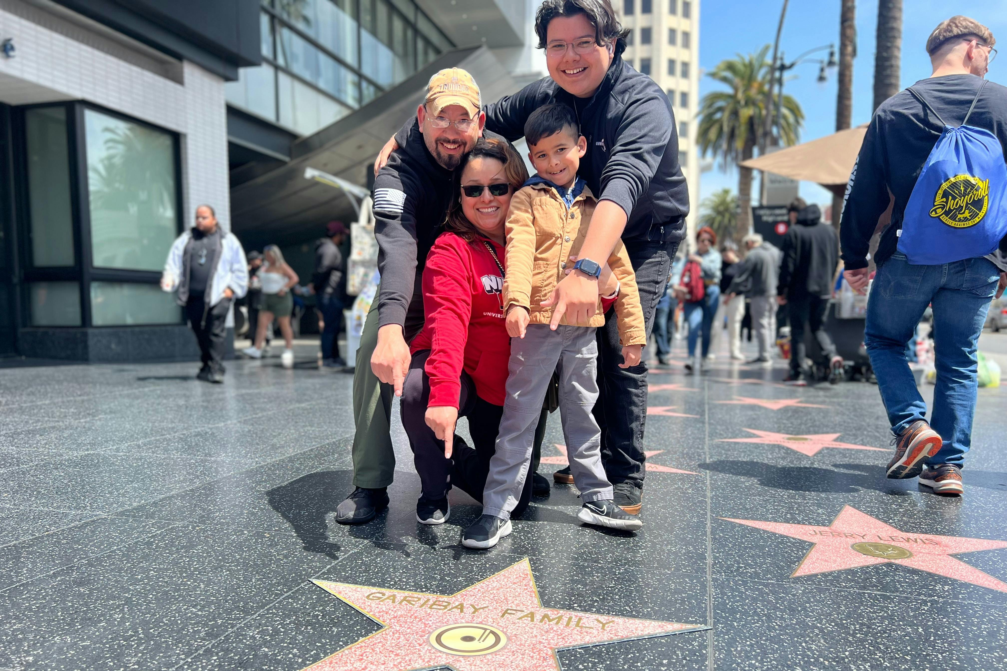 A  Hollywood Walk of Fame area  Tourist is happy with their own replica star personalized for a photo.#family