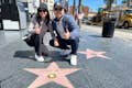 Un turista dell'area della Hollywood Walk of Fame è felice di avere una replica della sua stella personalizzata per una foto.#coppia
