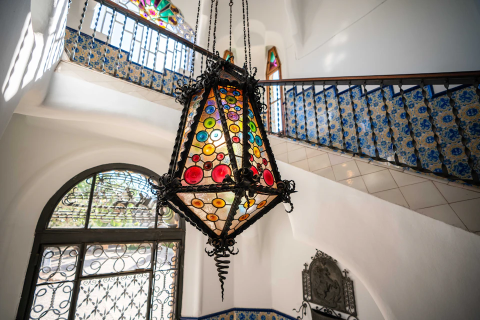 Large stained glass lamp combining stained glass and wrought iron techniques