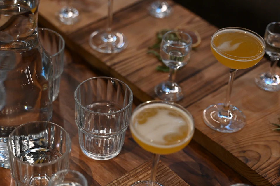 A board of cocktails and shots for tasting.