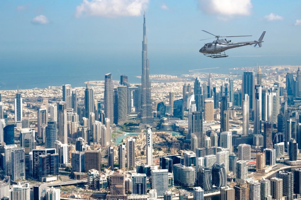 HeliDubai helicopter over the Business Bay with the clear view of the Burj Khalifa.