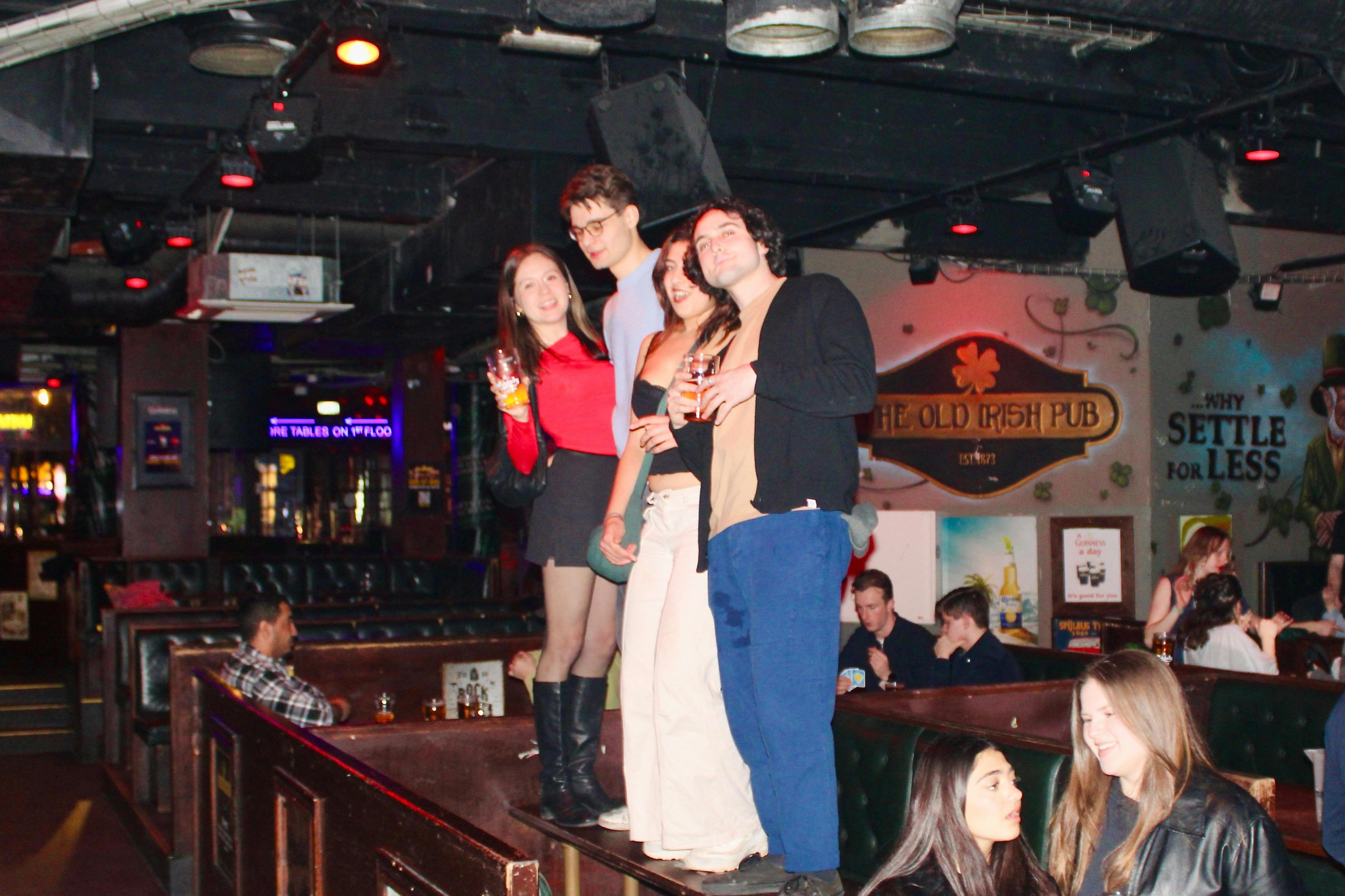Pub crawlers dancing on tables