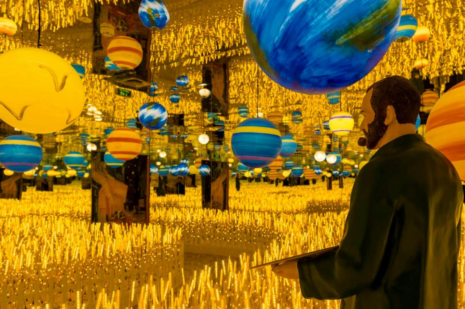 A room with floating planet models, mirrored walls, and numerous lit candles, with a statue of a man in the foreground.