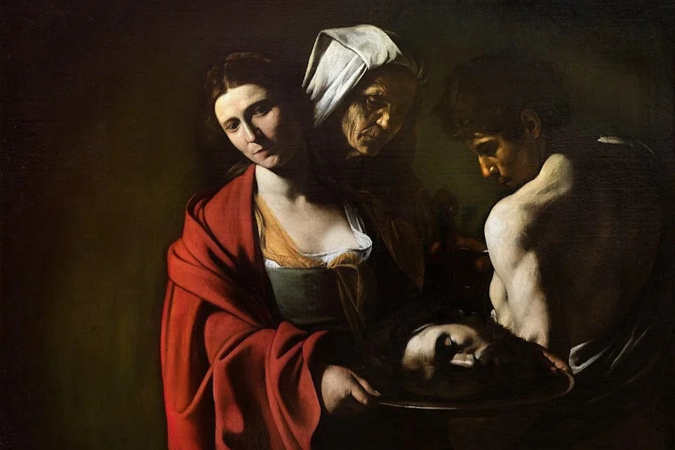 A dramatic painting of three people; a woman holding a platter with a severed head, an older woman, and a shirtless man.